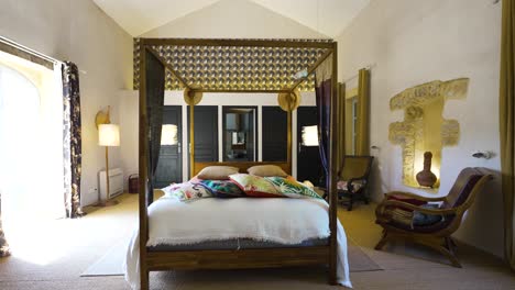 Slow-revealing-shot-of-an-antique-bedroom-with-a-poster-frame-in-Nimes