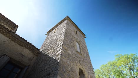Slow-orbiting-shot-around-a-stone-tower-joined-onto-a-luxury-villa-in-Nimes