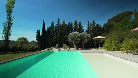 Slow-rising-shot-overhead-a-private-pool-in-the-garden-of-a-villa-in-Nimes