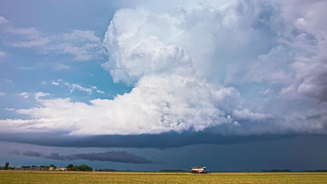 A-Time-Lapse-Shot-Of-A-Strong-Wind-Shear-Above-A-Field-Near-A-Small-Village
