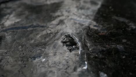 Water-streaming-under-frozen-stream,-flowing-water-under-ice,-abstract-ice-water