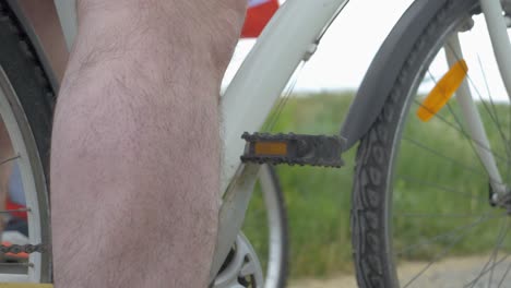 Slow-motion-close-up-shot-of-a-cyclist-putting-their-foot-on-the-pedal-ready-to-cycle