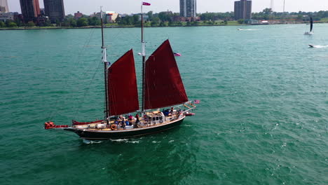 Aerial-view-of-a-schooner-on-the-Detroit-river,-sunny,-summer-day-at-US-Canada-border