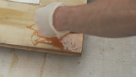 Brushing-out-Polyester-resin-over-Plywood-for-fiberglass
