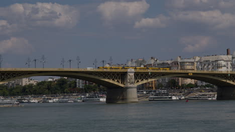 Budapest-Margit-Bridge-over-Danube,-Tram-Train-and-Cars-driving-on-top