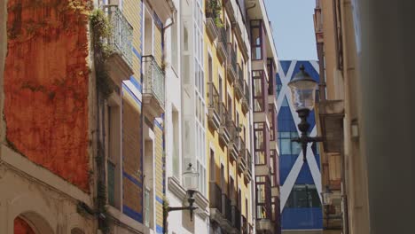 Handheld-slow-motion-clip-of-a-narrow-street-in-Gijon,-Asturias