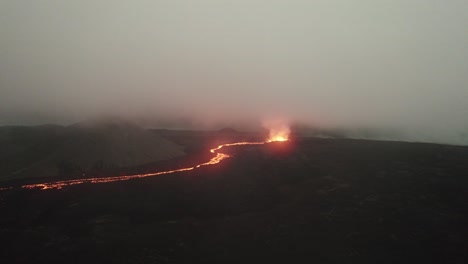 mid-angle-drone-shot-of-the-litli-hrutur-volcano-in-iceland-with-fog-and-smoke
