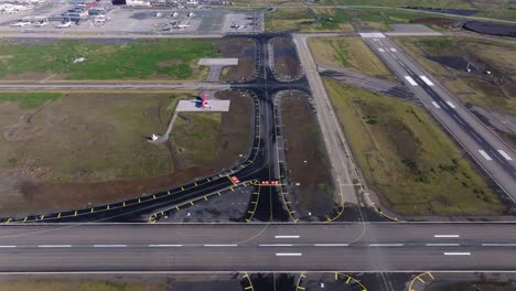 Newly-build-fresh-asphalt-taxiway-on-Iceland-airport,-aerial