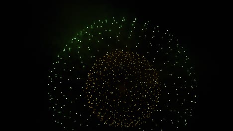 Fireworks-explode-into-round-ball-in-dark-night-sky,-festive-celebration