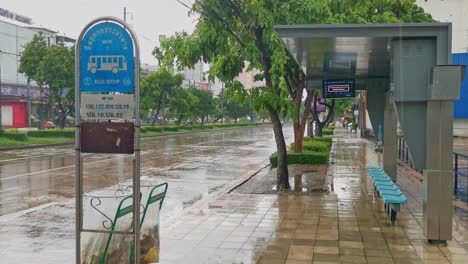 Rainfall-at-a-Bangkok-Bus-Shelter-on-the-Sidewalk-as-Traffic-Flows-By