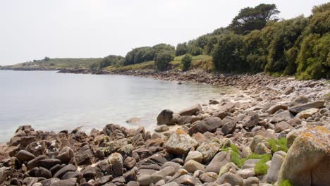 Extra-wide-shot-waves-lapping-on-the-rocky-shore-at-St-Agnes-at-the-Isles-of-Scilly
