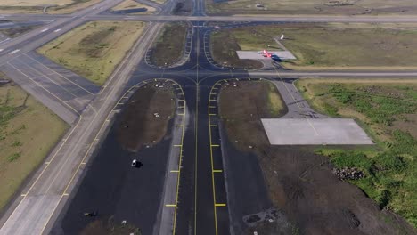 Above-airport-taxiway-on-clear-summer-day,-Airfield-concrete-tarmac