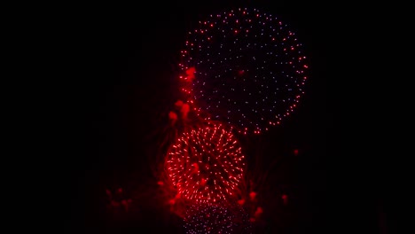Multiple-fireworks-explode-during-festival-in-dark-night-sky