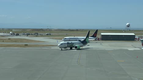 Flair-Airways-and-Air-Canada-Boeings-B737-Taxiing-at-Vancouver-Airport