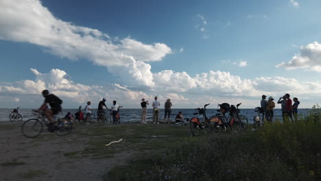 Wide-shot-of-cyclists-gathered-by-Lake-Ontario