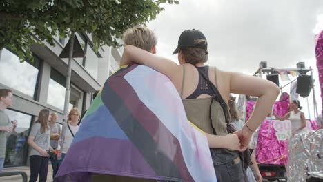 Lesbian-couple-walking-arm-in-arm-during-the-Antwerp-Pride-Parade-2023-in-Belgium