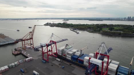 Cranes-loading-an-intermodal-container-ship,-4K-drone-clip