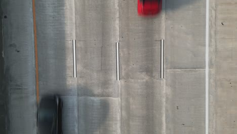 Aerial-POV-Looking-Straight-Down-of-Cars-Driving-on-4-Lane-Highway,-Moving-from-Bottom-to-Top-of-Frame