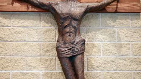 Brown-Metal-Sculpture-Of-Jesus-Christ-Crucifixion-Hanging-On-Church-Wall