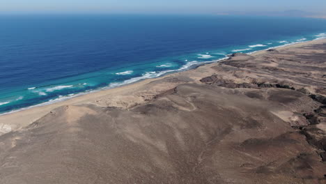 Cofete-beach,-Fuerteventura:-panoramic-aerial-view-over-the-fantastic-beach-on-a-sunny-day-and-turquoise-waters