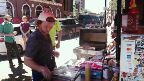 Street-vendor-preparing-hot-dogs-for-customers