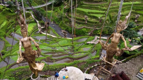 Aerial:-Gigantic-Statues-Dewi-Sri,-Goddes-of-Rice-in-Alas-Harum-Rice-Terrraces-showing-construction-skills-and-local-religious-Art