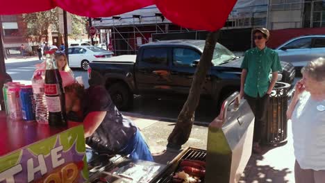 Hot-dog-seller-talking-to-older-customer-in-Portland,-Maine