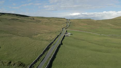 An-aerial-view-of-Cam-Gill-Road-in-the-Yorkshire-Dales-on-a-sunny-summer-evening,-Englenad,-UK