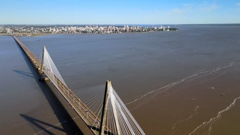 Aerial-image-of-San-Roque-González-Bridge-that-crosses-the-Paraná-River-between-the-cities-of-Posadas,-capital-of-Misiones-Province,-Argentina-and-Encarnación,-capital-of-Itapúa,-Paraguay
