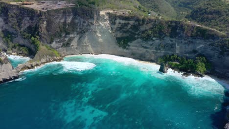 Discover-the-allure-of-Diamond-Beach,-Nusa-Penida,-Bali,-Indonesia,-through-our-captivating-aerial-stock-footage