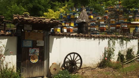 Slow-push-shot-to-walled-entrance-of-traditional-Bulgarian-bee-farm