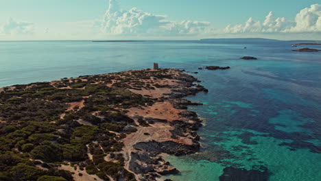 Torre-De-Ses-Portes-And-Its-Scenic-Surroundings-In-Ibiza,-Spain---aerial-shot