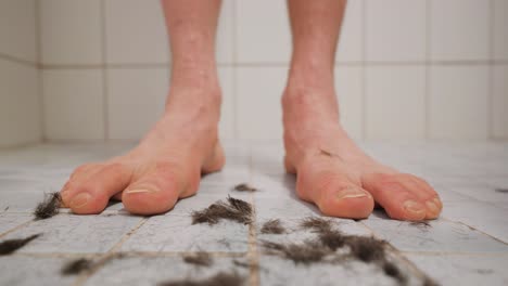 Dark-hair-falling-in-front-of-a-man's-feet