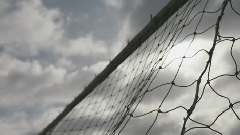 Slow-motion-of-goal-scored-as-ball-hit-net-in-football-field-during-evening
