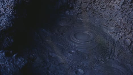 Close-up-of-bubbles-bursting-in-mud-pool,-active-geothermal-location