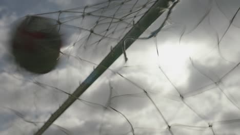 Close-up-of-a-goal-scored-as-football-hits-into-net-on-field