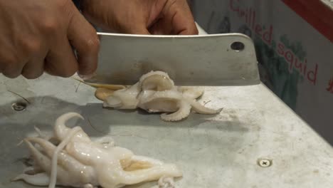 cutting-processing-cuttlefish-on-counter-at-street-food-restaurant