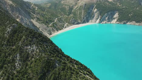 Stunning-views-of-Myrtos-Beach-surrounded-by-rocky-mountains-and-turquoise-colored-water,-Greece