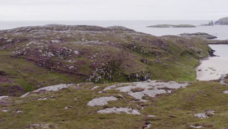 Drone-shot-circling-the-cemetery-and-Iron-Age-House-at-Bosta-beach-on-the-Isle-of-Bernera,-near-the-Isle-of-Lewis-on-the-Outer-Hebrides-of-Scotland