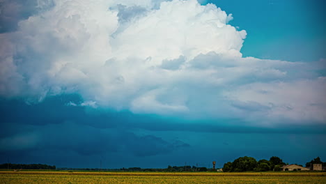 Combine-harvesters-gather-crops-under-a-dramatic-cloudscape---time-lapse
