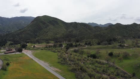 Aerial-wide-rising-shot-of-the-barren-land-reclaimed-by-nature-where-the-historic-Paramount-Ranch-movie-backlot-once-stood-before-burning-to-the-ground-in-2018