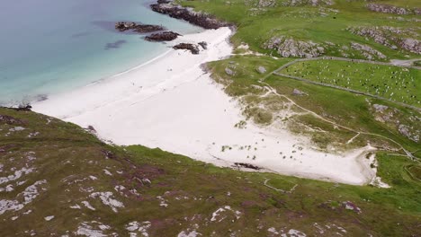 Drone-shot-of-the-cemetery-and-Iron-Age-House-at-Bosta-beach-on-the-Isle-of-Great-Bernera,-near-the-Isle-of-Lewis-on-the-Outer-Hebrides-of-Scotland