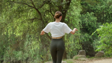 Rear-View-Of-Sporty-Woman-Walking-in-a-Park-After-Morning-Exercises---slow-motion