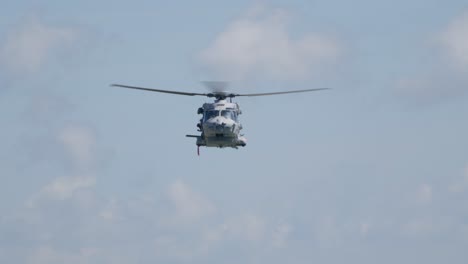 Frontal-View-of-Military-NH90-Helicopter-Hovering-and-Lowering-Hoist