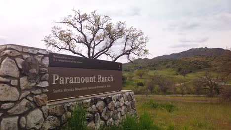 Gimbal-booming-down-and-panning-shot-of-the-entrance-sign-to-Paramount-Ranch-in-Agoura-Hills,-California