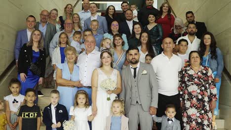 Bride-and-groom-standing-between-family-and-friends-at-the-wedding-ceremony