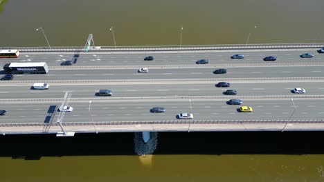 Aerial-view-of-traffic-moving-on-a-massive-bridge-over-the-Vistula-River-in-Warsaw