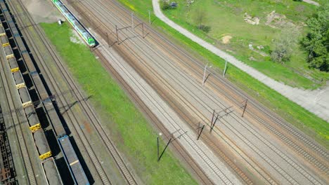 Flying-above-industrial-railroad-station-with-cargo-trains-and-freight-containers