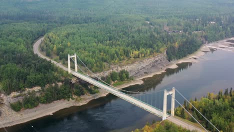 Drone-captures-stunning-aerial-view-of-Peace-River-Suspension-Bridge-in-Hudson's-Hope,-BC