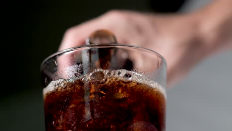 Pouring-Coke-cola-into-a-glass-from-a-soda-bottle-outdoors---closeup---low-angle-view